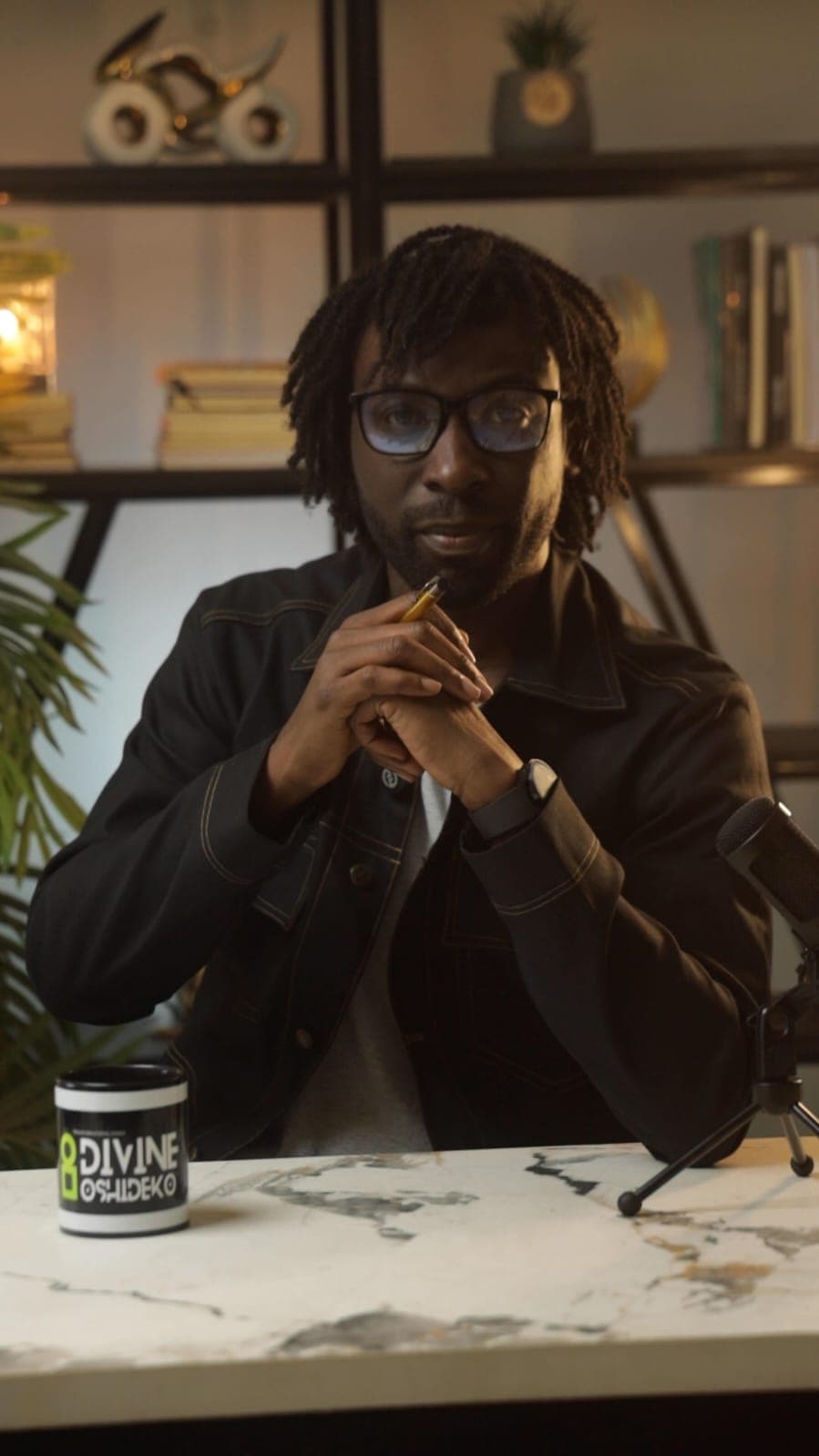 Divine Oshideko seated in the Trybe Talk studio, looking directly at the camera